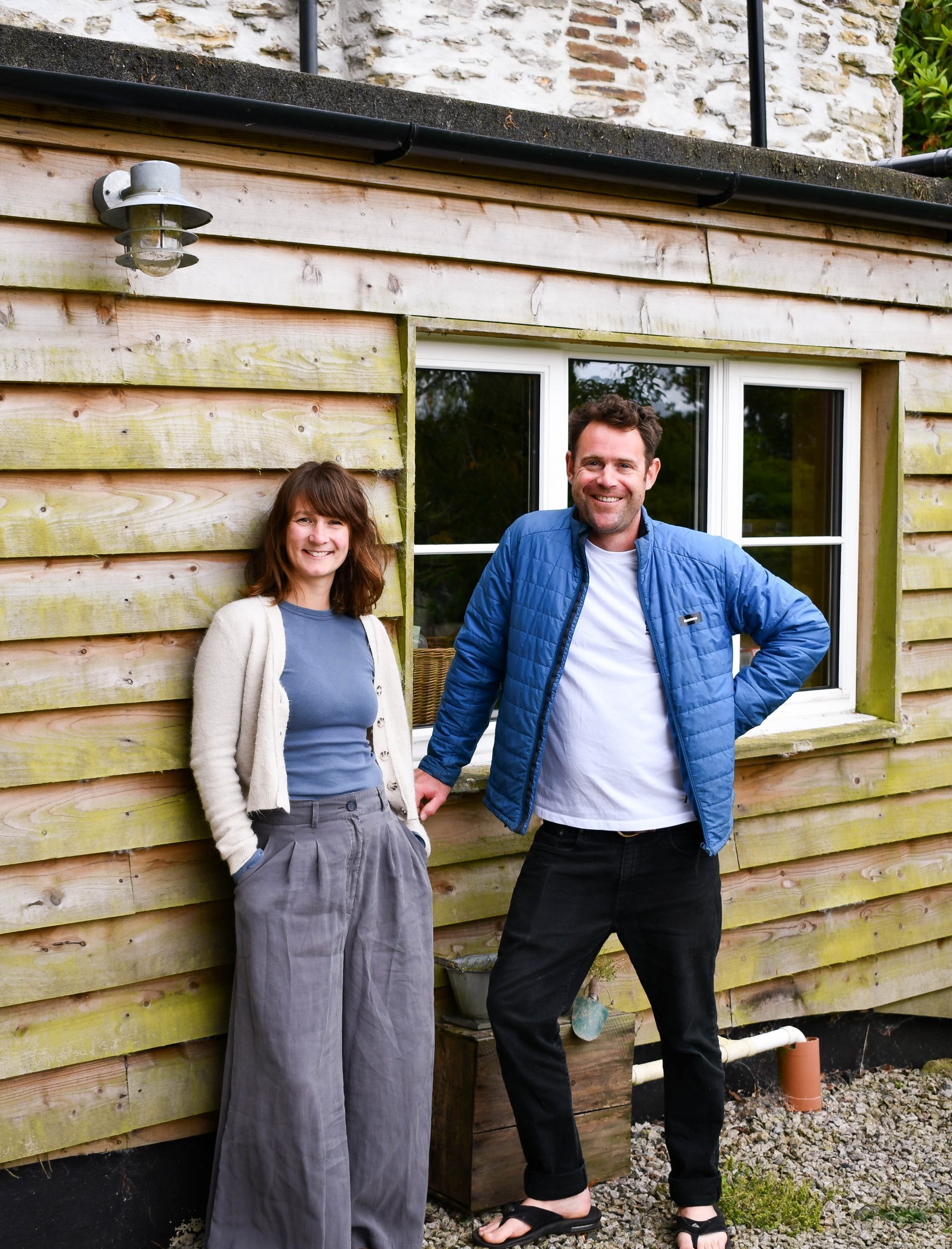 Charlotte and Joe Colehan leaning against some wooden cladding