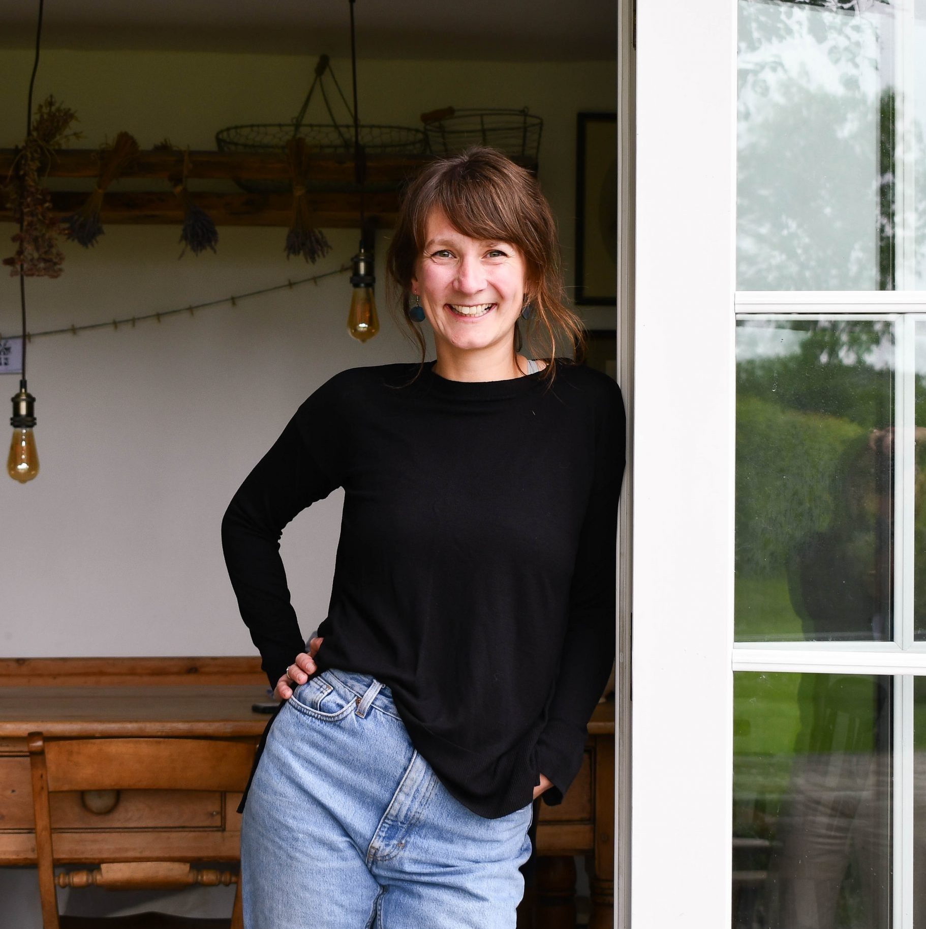 image of business owner Charlotte Colehan, smiling and leaning on an open doorway